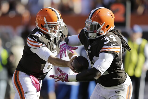 Cleveland Browns quarterback Brian Hoyer hands off to running back Isaiah Crowell during an NFL football game against the Pittsburgh Steelers Sunday, Oct. 12, 2014, in Cleveland. (AP Photo/Tony Dejak)