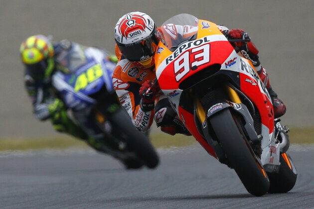 Spain's rider Marc Marquez steers his Honda tailed by Italy's rider Valentino Rossi on Yamaha  during the Japanese Grand Prix at Twin Ring Motegi circuit in Motegi, north of Tokyo, Japan, Sunday, Oct. 12, 2014.  Honda rider Marquez defended his MotoGP championship on Sunday when he finished second in the Grand Prix of Japan behind compatriot Jorge Lorenzo. Rossi finished in third. (AP Photo/Shizuo Kambayashi)