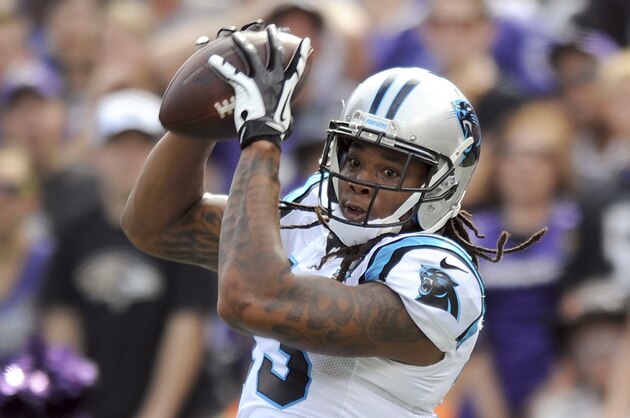 Carolina Panthers wide receiver Kelvin Benjamin (13) pulls in a touchdown pass in front of Baltimore Ravens free safety Darian Stewart (24) during the first half of an NFL football game in Baltimore, Sunday, Sept. 28, 2014. (AP Photo/Gail Burton)