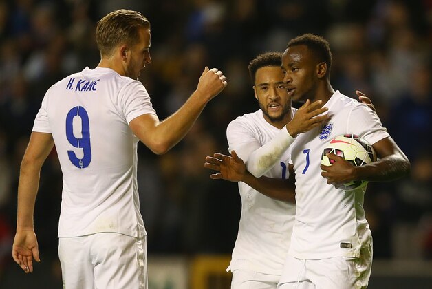 WOLVERHAMPTON, ENGLAND - OCTOBER 10:  Saido Berahino of England is congratulated by team mates Nathan Redmond and Harry Kane after he was fouled by Dominik Livakovic of Croatia to be awarded a penalty which he scored to win the match during the UEFA U21 Championship Playoff First Leg match between England and Croatia at Molineux on October 10, 2014 in Wolverhampton, England.  (Photo by Clive Brunskill/Getty Images)