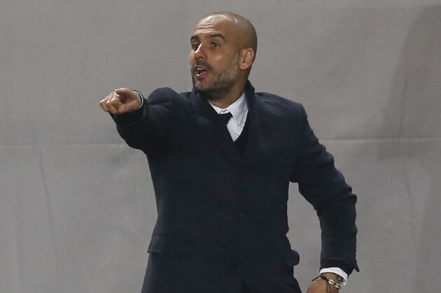 Bayern's head coach Pep Guardiola gives instructions to his players during the Group E Champions League match between CSKA Moscow and Bayern Munich at Arena Khimki stadium in Moscow, Russia, Tuesday Sept. 30, 2014. (AP Photo/Pavel Golovkin)
