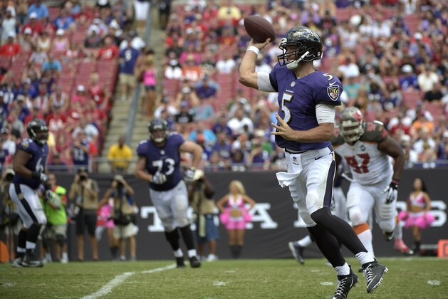 Baltimore Ravens quarterback Joe Flacco (5) throws a pass as Tampa Bay Buccaneers defensive tackle Akeem Spence (97) pursues during the second half of an NFL football game in Tampa, Fla., Sunday, Oct. 12, 2014. (AP Photo/Phelan M. Ebenhack)