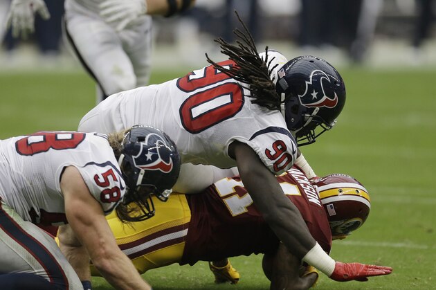 Houston Texans linebacker Jadeveon Clowney (90) and outside linebacker Brooks Reed (58) tackle Washington Redskins wide receiver DeSean Jackson (11) during the second quarter of an NFL football game Sunday, Sept. 7, 2014, in Houston. (AP Photo/David J. Phillip)