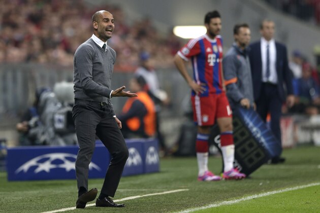 Bayern's head coach Pep Guardiola of Spain gestures during the Champions League Group E soccer match between FC Bayern Munich and Manchester City at Allianz Arena in Munich, southern Germany, Wednesday Sept. 17, 2014. (AP Photo/Matthias Schrader)