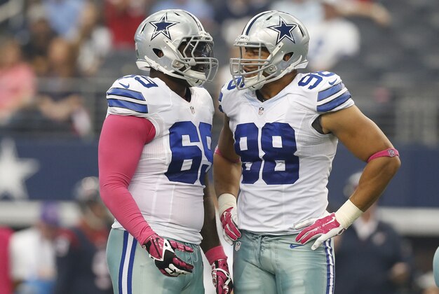 Oct 5, 2014; Arlington, TX, USA; Dallas Cowboys defensive tackle Henry Melton (69) talk with defensive end Tyrone Crawford (98) during the third quarter against the Houston Texans at AT&T Stadium. Mandatory Credit: Matthew Emmons-USA TODAY Sports