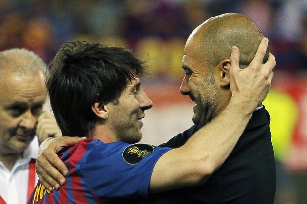 FC Barcelona's Lionel Messi from Argentina, left,  celebrates his victory with coach Josep Guardiola during the final Copa del Rey  soccer match against Athletic Bilbao at the Vicente Calderon stadium in Madrid, Spain, Friday, May 25, 2012. (AP Photo/Andres Kudacki)