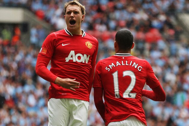 LONDON, ENGLAND - AUGUST 07:  Phil Jones of Manchester United celebrates with goalscorer Chris Smalling during the FA Community Shield match sponsored by McDonald's between Manchester City and Manchester United at Wembley Stadium on August 7, 2011 in London, England.  (Photo by Ian Walton/Getty Images)
