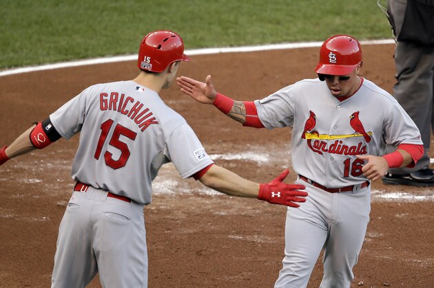 St. Louis Cardinals' Kolten Wong, right,  celebrates with Randal Grichuk after scoring against the San Francisco Giants during the second inning of Game 4 of the National League baseball championship series Wednesday, Oct. 15, 2014, in San Francisco. (AP Photo/Eric Risberg)