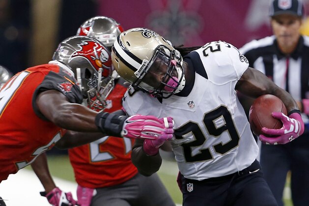 New Orleans Saints running back Khiry Robinson (29) is tackled by Tampa Bay Buccaneers outside linebacker Lavonte David in the first half of an NFL football game in New Orleans, Sunday, Oct. 5, 2014. (AP Photo/Jonathan Bachman)
