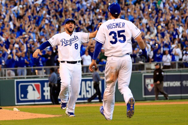 KANSAS CITY, MO - OCTOBER 15:  Eric Hosmer #35 and Mike Moustakas #8 of the Kansas City Royals celebrate their 2 to 1 win over the Baltimore Orioles to sweep the series in Game Four of the American League Championship Series at Kauffman Stadium on October 15, 2014 in Kansas City, Missouri.  (Photo by Jamie Squire/Getty Images)