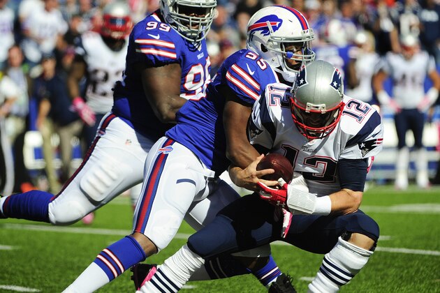 Buffalo Bills defensive end Jerry Hughes (55) sacks New England Patriots quarterback Tom Brady (12) during the first half of an NFL football game Sunday, Oct. 12, 2014, in Orchard Park, N.Y. (AP Photo/Gary Wiepert)