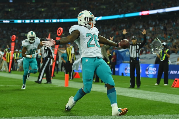 Miami Dolphins' Lamar Miller celebrates after scoring a touchdown during the NFL football game against Oakland Raiders at Wembley Stadium in London, Sunday, Sept. 28, 2014. (AP Photo/Tim Ireland)