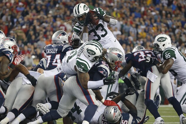 New York Jets running back Chris Ivory (33) goes over the top for a touchdown in the third quarter of an NFL football game against the New England Patriots Thursday, Oct. 16, 2014, in Foxborough, Mass. (AP Photo/Elise Amendola)