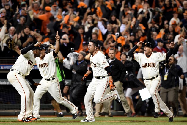 SAN FRANCISCO, CA - OCTOBER 16:  Travis Ishikawa #45 of the San Francisco Giants celebrates with Santiago Casilla #46 after Ishikawa hits a three-run walk-off home run to defeat the St. Louis Cardinals 6-3 during Game Five of the National League Championship Series at AT&T Park on October 16, 2014 in San Francisco, California.  (Photo by Thearon W. Henderson/Getty Images)