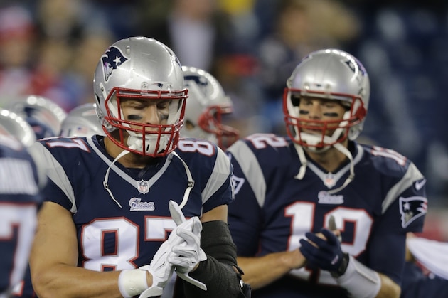 New England Patriots quarterback Tom Brady (12) and wide receiver Rob Gronkowski walk onto the field before an NFL football game Thursday, Oct. 16, 2014, in Foxborough, Mass. (AP Photo/Charles Krupa)