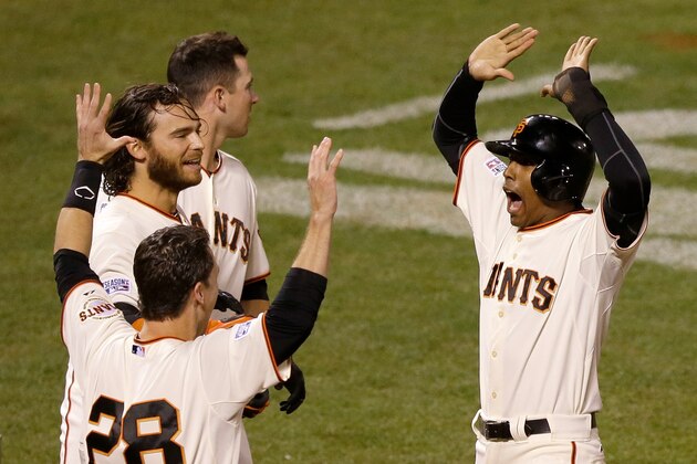 SAN FRANCISCO, CA - OCTOBER 16:  Joaquin Arias #13 of the San Francisco Giants celebrates after Travis Ishikawa #45 hits a three-run walk-off home run to defeat the St. Louis Cardinals 6-3 during Game Five of the National League Championship Series at AT&T Park on October 16, 2014 in San Francisco, California.  (Photo by Jason O. Watson/Getty Images)