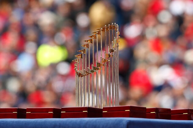 BOSTON, MA - APRIL 04:  The World Series trophy sits among the championship rings prior to the Opening Day game between the Boston Red Sox and the Milwaukee Brewers at Fenway Park on April 4, 2014 in Boston, Massachusetts.  (Photo by Jared Wickerham/Getty Images)