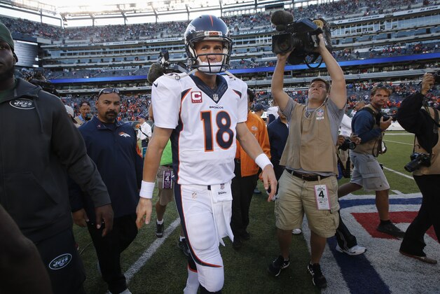 Denver Broncos quarterback Peyton Manning (18) walks off the field after the Broncos beat the New York Jets 31-17 in an NFL football game, Sunday, Oct. 12, 2014, in East Rutherford, N.J. (AP Photo/Kathy Willens)