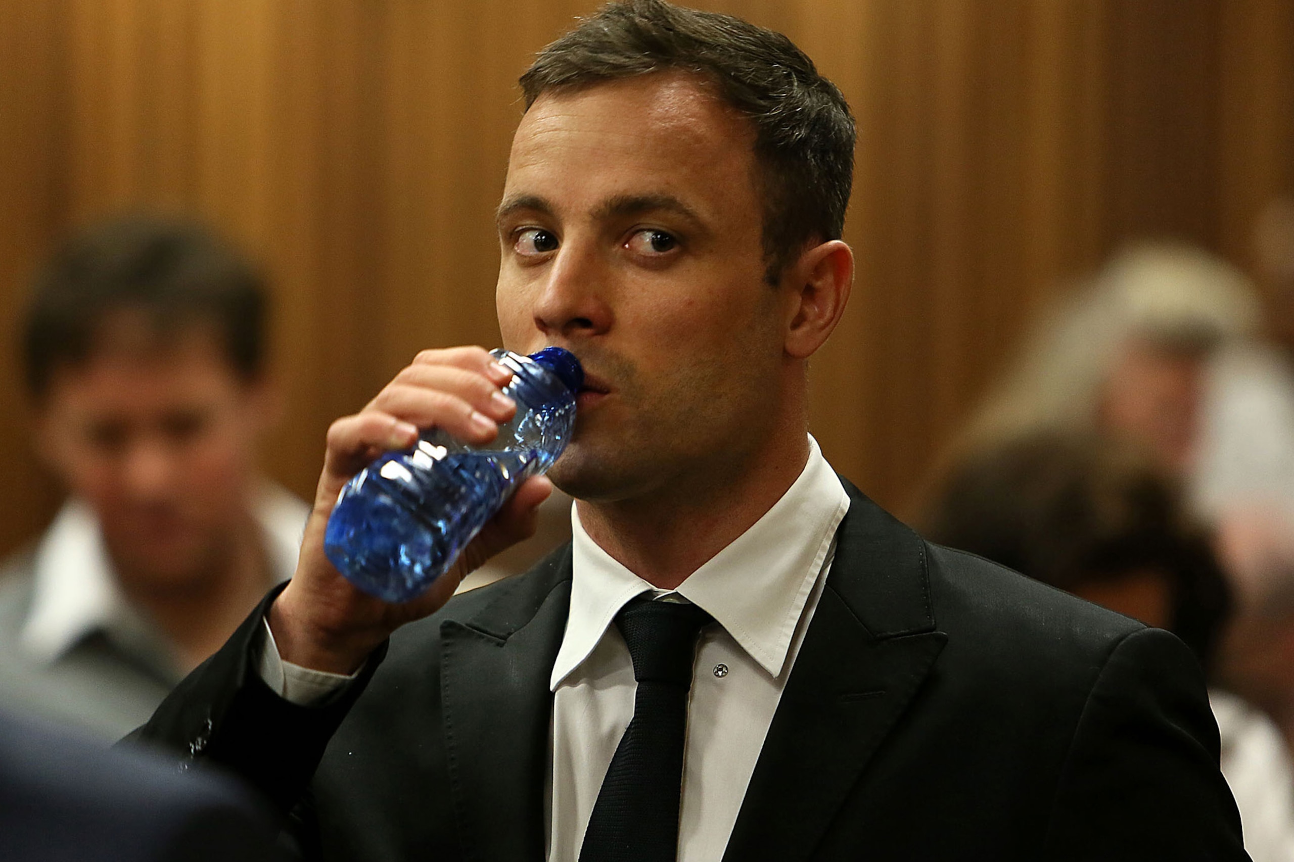 Oscar Pistorius, sips water,  at the end of the fourth day of  sentencing proceedings in the high court in Pretoria,  South Africa, Thursday, Oct. 16, 2014. Following the testimony hearing, which is expected to end this week, Judge Thokozile Masipa will rule on what punishment Pistorius must serve after convicting him of culpable homicide for shooting his girlfriend Reeva Steenkamp through a toilet door in his home.(AP Photo/Alon Skuy, Pool)