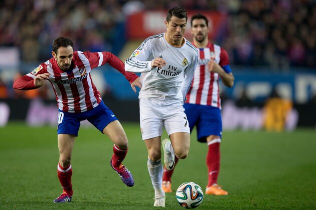 MADRID, SPAIN - FEBRUARY 11: Cristiano Ronaldo (2ndL) of Real Madrid CF competes for the ball with Juan Francisco Torres alias Juanfran (L) of Atletico de Madrid and his teammate Raul Garcia (R) during the Copa del Rey semi-final second leg match between Club Atletico de Madrid and Real Madrid CF at Vicente Calderon Stadium on February 11, 2014 in Madrid, Spain.  (Photo by Gonzalo Arroyo Moreno/Getty Images)
