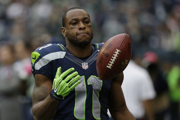 Seattle Seahawks wide receiver Percy Harvin stands on the sideline late in the second half of the Seattle Seahawks' 30-23 loss to the Dallas Cowboys in an NFL football game, Sunday, Oct. 12, 2014, in Seattle. (AP Photo/Elaine Thompson)