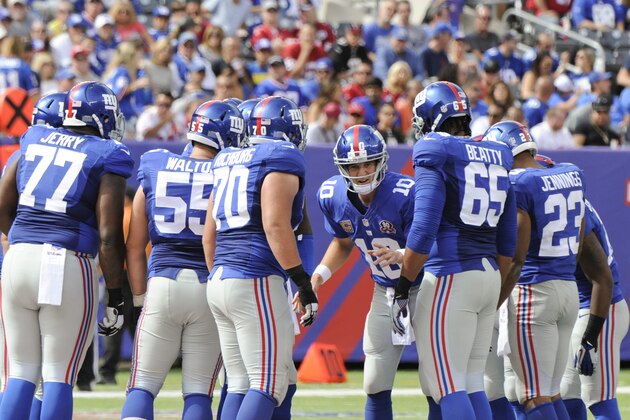 New York Giants quarterback Eli Manning (10) talks to his teammates in the huddle during the second half of an NFL football game against the Arizona Cardinals Sunday, Sept. 14, 2014, in East Rutherford, N.J.  (AP Photo/Bill Kostroun)