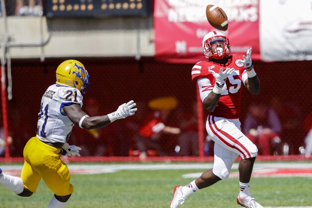Nebraska wide receiver De'Mornay Pierson-El (15) catches a punt return against McNeese State defensive back Aaron Sam (21) in the second half of an NCAA college football game in Lincoln, Neb., Saturday, Sept. 6, 2014. Nebraska won 31-24. (AP Photo/Nati Harnik)