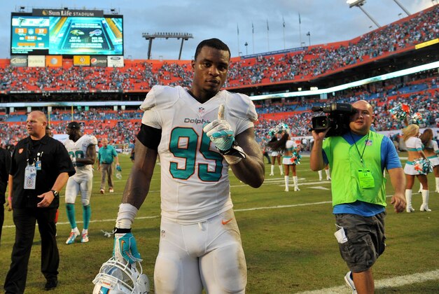 Sep 22, 2013; Miami Gardens, FL, USA; Miami Dolphins defensive end Dion Jordan (95) reacts after defeating the Atlanta Falcons at Sun Life Stadium. Mandatory Credit: Steve Mitchell-USA TODAY Sports