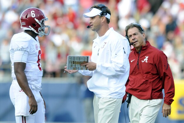 Oct 4, 2014; Oxford, MS, USA; Alabama Crimson offensive coordinator Lane Kiffin talks with quarterback Blake Sims (6) as head coach Nick Saban looks on during the second half against Mississippi Rebels at Vaught-Hemingway Stadium. Mandatory Credit: Christopher Hanewinckel-USA TODAY Sports