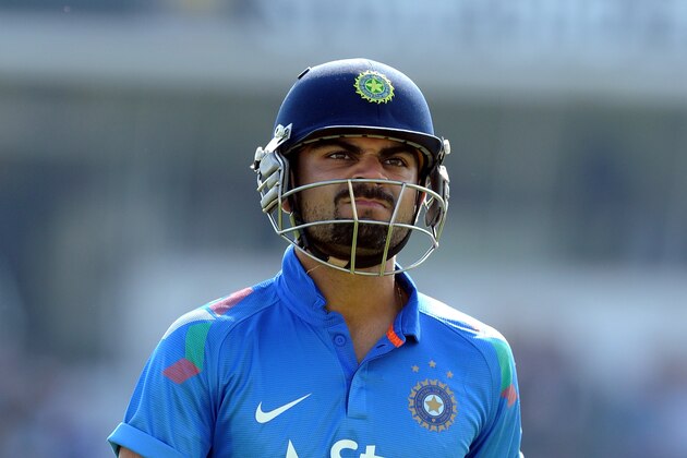 India's Virat Kohli after being bowled by England's James Anderson caught Alastair Cook for 13 runs during the fifth One Day International match between England and India at Headingley cricket ground, Leeds, England, Friday, Sept 5, 2014. (AP Photo/Rui Vieira)