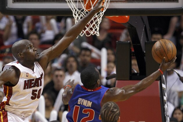 Detroit Pistons' Will Bynum (12) goes to the basket as Miami Heat's Joel Anthony (50) defends in the third quarter of an NBA basketball game in Miami, Friday, April 9, 2010. The Pistons won 106-99. (AP Photo/Alan Diaz)