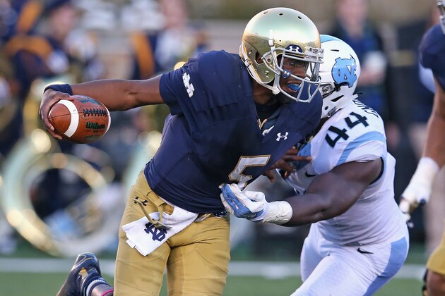 SOUTH BEND, IN - OCTOBER 11:  Everett Golson #5 of the Notre Dame Fighting Irish breaks away from Junior Gnonkonde #44 of the North Carolina Tar Heels at Notre Dame Stadium on October 11, 2014 in South Bend, Indiana. Notre Dame defeated North Carolina 50-43.  (Photo by Jonathan Daniel/Getty Images)
