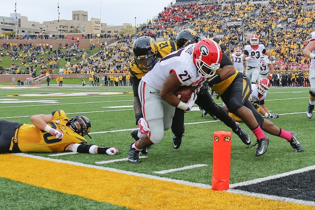 COLUMBIA, MO - OCTOBER 11:  Darvin Ruise #12 and Thomas Wilson #8 of the Missouri Tigers fail to keep Nick Chubb #27 of the Georgia Bulldogs out of the end zone late in the fourth quarter on October 11, 2014 at Faurot Field/Memorial Stadium in Columbia, Missouri. (Photo by Kyle Rivas/Getty Images)