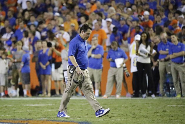 Florida head coach Will Muschamp  walks off the field after checking on an injured player during the second half of an NCAA college football game against LSU in Gainesville, Fla., Saturday, Oct. 11, 2014. LSU won the game 30-27. (AP Photo/John Raoux)