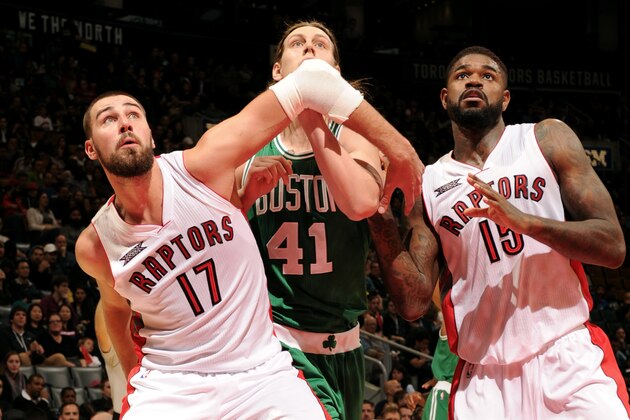 TORONTO, CANADA - October 10: Amir Johnson #15 and Jonas Valanciunas #17 of the Toronto Raptors battle for position against Kelly Olynyk #41 of the Boston Celtics during the game on October 10, 2014 at the Air Canada Centre in Toronto, Ontario, Canada.  NOTE TO USER: User expressly acknowledges and agrees that, by downloading and or using this Photograph, user is consenting to the terms and conditions of the Getty Images License Agreement.  Mandatory Copyright Notice: Copyright 2014 NBAE (Photo by Ron Turenne/NBAE via Getty Images)