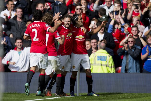 Manchester United's Radamel Falcao Garcia, right, celebrates with teammates after scoring against Everton during their English Premier League soccer match at Old Trafford Stadium, Manchester, England, Sunday Oct. 5, 2014. (AP Photo/Jon Super)