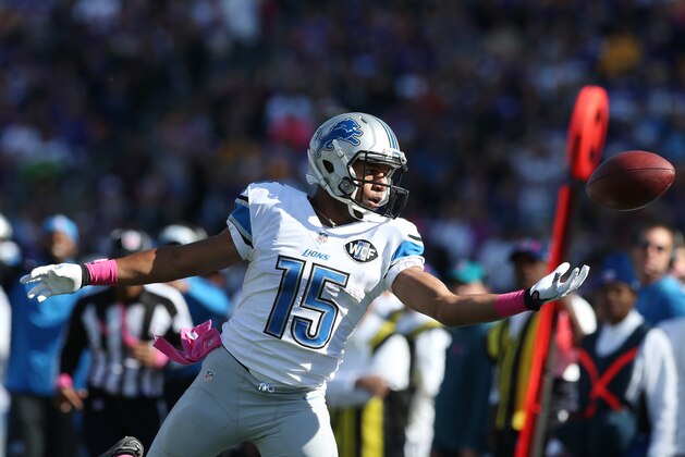 Detroit Lions wide receiver Golden Tate (15) reaches for a pass during the second half of an NFL football game against the Minnesota Vikings, Sunday, Oct. 12, 2014, in Minneapolis. (AP Photo/Jim Mone)