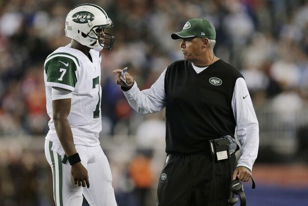 New York Jets coach Rex Ryan, right, talks to quarterback Geno Smith in the first half of the Jets' NFL football game against the New England Patriots on Thursday, Oct. 16, 2014, in Foxborough, Mass. (AP Photo/Charles Krupa)
