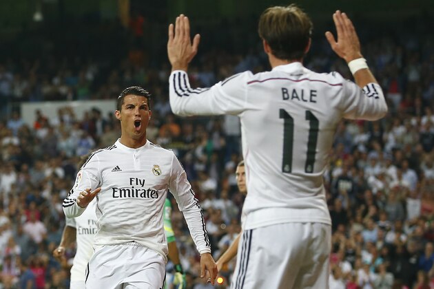 Real's Cristiano Ronaldo, left, celebrates his goal with Gareth Bale, right, during a Spanish La Liga soccer match between Real Madrid and Athletic Bilbao at the Santiago Bernabeu stadium in Madrid, Spain, Sunday, Oct. 5, 2014. (AP Photo/Andres Kudacki)