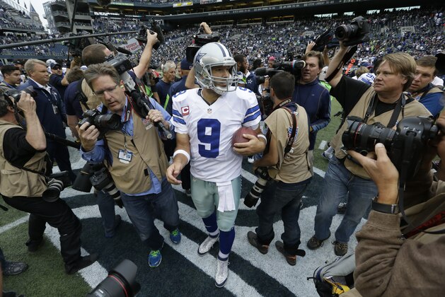 Dallas Cowboys quarterback Tony Romo is surrounded by photographers after an NFL football game against the Seattle Seahawks, Sunday, Oct. 12, 2014, in Seattle. (AP Photo/Elaine Thompson) Dallas Cowboys quarterback Tony Romo is surrounded by photographers after an NFL football game against the Seattle Seahawks, Sunday, Oct. 12, 2014, in Seattle. (AP Photo/Elaine Thompson)