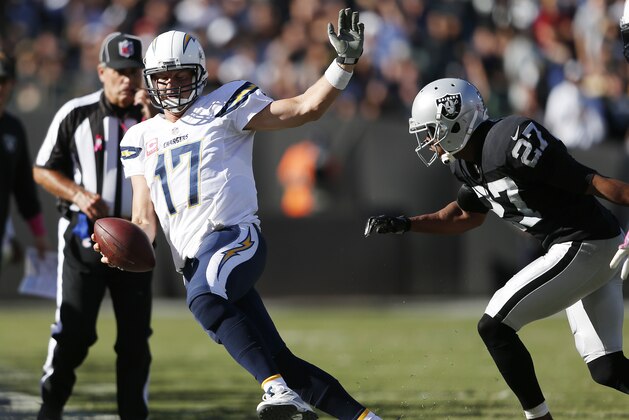 OAKLAND, CA - OCTOBER 12:  Quarterback Philip Rivers #17 of the San Diego Chargers scrambles nine yards for a first down before being forced out of bounds by Carlos Rogers #27 of the Oakland Raiders during the fourth quarter at the O.co Coliseum in Oakland, California. The Chargers won the game 31-28. (Photo by Thearon W. Henderson/Getty Images)