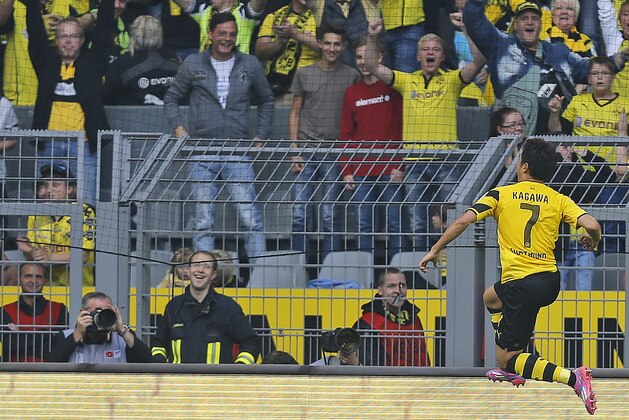 Dortmund’s Shinji Kagawa from Japan, right, celebrates after scoring during the German first division Bundesliga soccer match between BvB Borussia Dortmund  and SC Freiburg in Dortmund, Germany, Saturday, Sept. 13, 2014. (AP Photo/Frank Augstein)