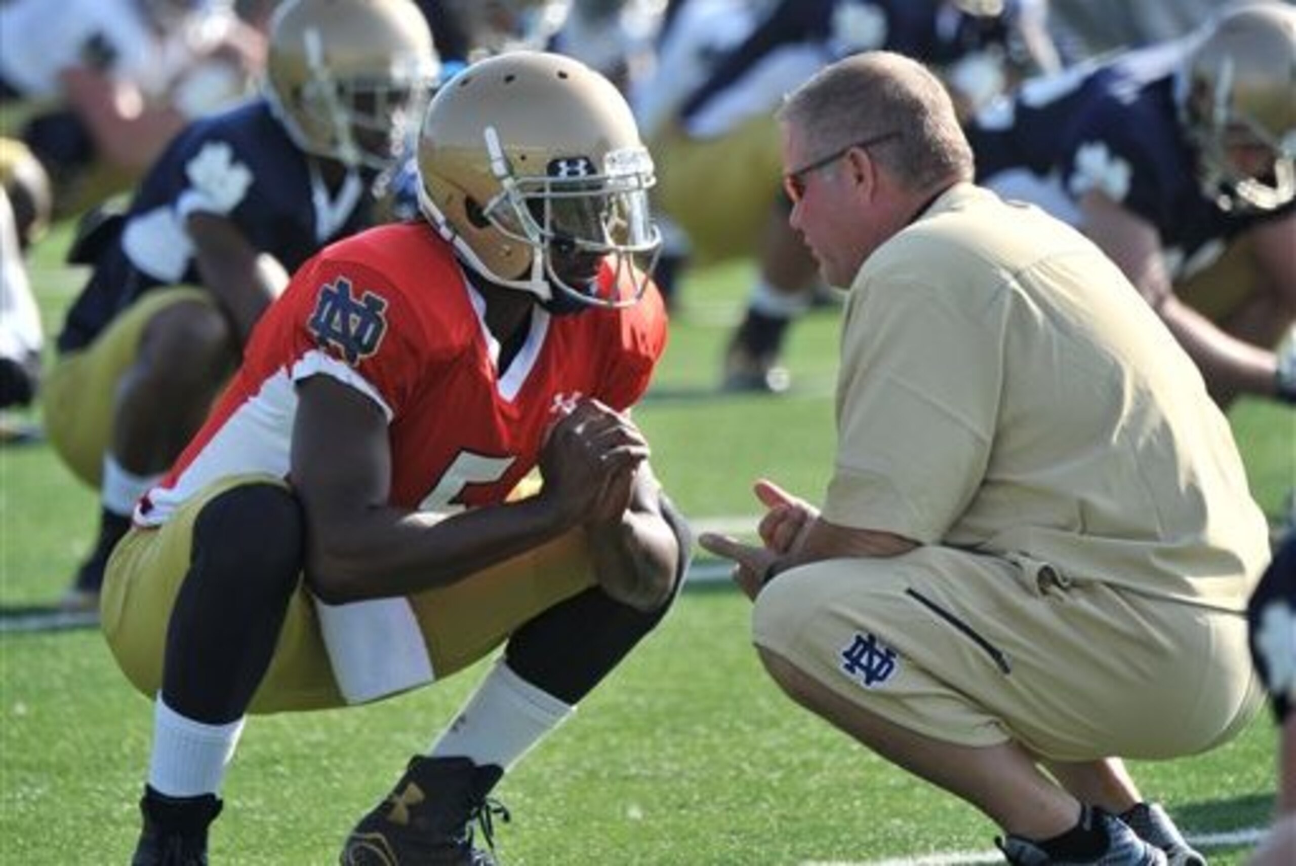 FILE - In this Aug. 9, 2014, file photo, Notre Dame coach Brian Kelly, right, talks with quarterback Everett Golson during practice in South Bend, Ind. Golson has reclaimed the job as Notre Dame's starting quarterback after being suspended last semester for academic impropriety. Coach Brian Kelly on Wednesday, Aug. 13, 2014, said Golson would start against Rice on Aug. 30 and said he hopes he will be the starter for the entire season.  (AP Photo/Joe Raymond, FILE)