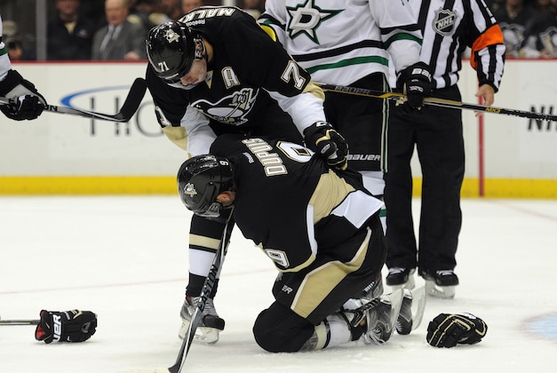 Oct 16, 2014; Pittsburgh, PA, USA; Pittsburgh Penguins right wing Pascal Dupuis (9) is help by teammate Evgeni Malkin (71) after being injured during the second period of an NHL game against the Dallas Stars at Consol Energy Center. Mandatory Credit: Don Wright-USA TODAY Sports