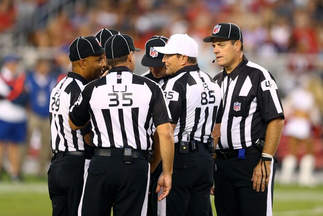 Aug 9, 2014; Glendale, AZ, USA; NFL referee Ed Hochuli (85) talks with other officials during the game between the Arizona Cardinals against the Houston Texans during a preseason game at University of Phoenix Stadium. Mandatory Credit: Mark J. Rebilas-USA TODAY Sports