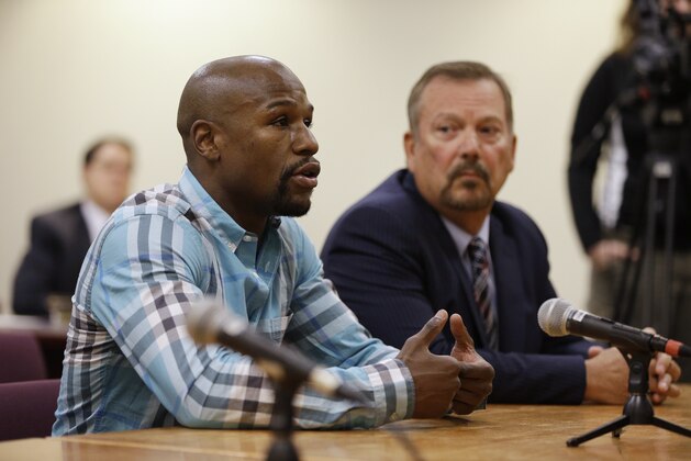 Boxer Floyd Mayweather Jr., left, appears with attorney Shane Emerick before the Nevada Athletic Commission Tuesday, Sept. 23, 2014, in Las Vegas. Mayweather appeared before the commission to answer questions about scenes aired on the reality show