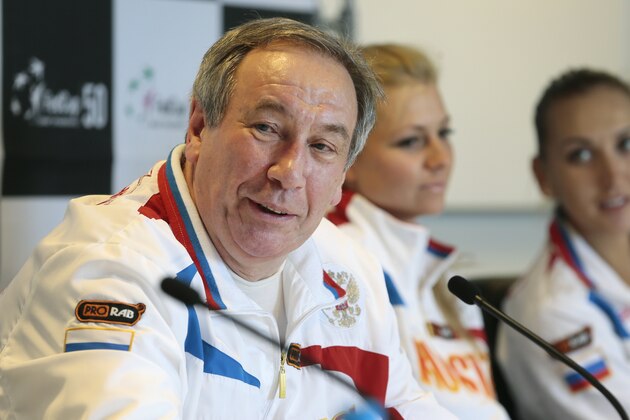 Russia's  team captain Shamil Tarpischev speaks during a news conference prior to the Fed Cup match between Russia and Slovakia in Moscow, Russia, Tuesday, April 16, 2013. Russia's tennis players Maria Kirilenko at center and Elena Vesnina at right. (AP Photo/Mikhail Metzel)