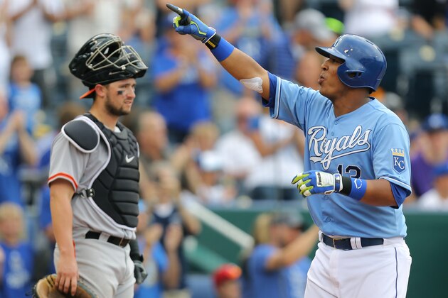 KANSAS CITY, MO - AUGUST 10:  Salvador Perez #13 of the Kansas City Royals celebrates his two-run home run as Andrew Susac #34 of the San Francisco Giants looks on in the fourth inning at Kauffman Stadium on August 10, 2014 in Kansas City, Missouri. (Photo by Ed Zurga/Getty Images)