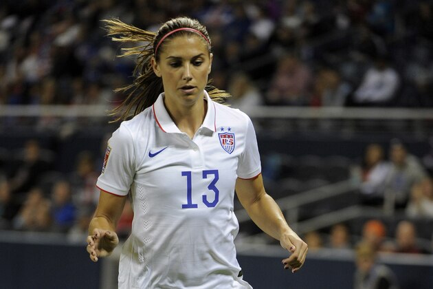 Oct 15, 2014; Kansas City, MO, USA; USA forward Alex Morgan (13) moves the ball against Trinidad in the second half during a women's World Cup qualifier soccer match at Sporting Park. USA won the game 1-0. Mandatory Credit: John Rieger-USA TODAY Sports