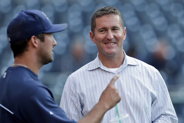 San Diego Padres general manager Josh Byrnes, right, listens to pitcher Huston Street during warmups for a baseball game against the New York Mets, Friday, Aug. 16, 2013, in San Diego. (AP Photo/Lenny Ignelzi)